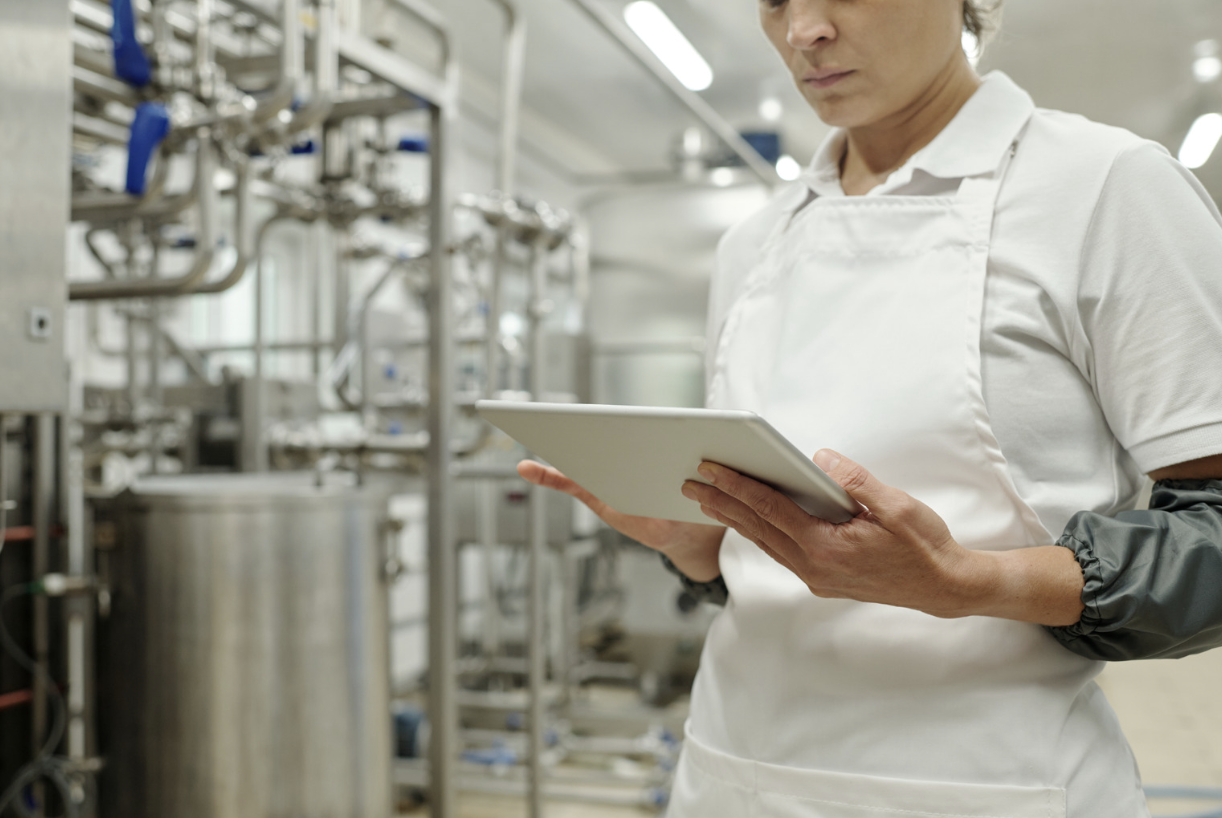 Manufacturing worker with tablet on plant floor